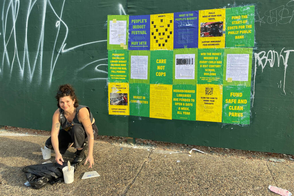 BlancheBrown-artists-peoplesbudgetfestival Artist Blanche Brown puts up posters for the People's Budget Festival.