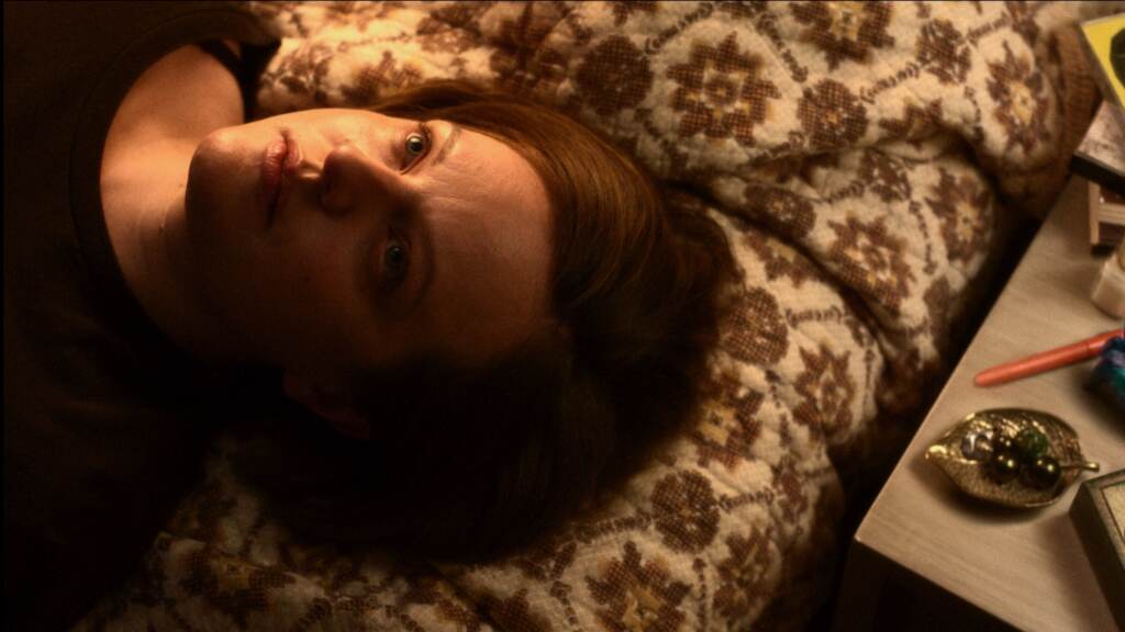 Elizabeth moss laying down staring upwards