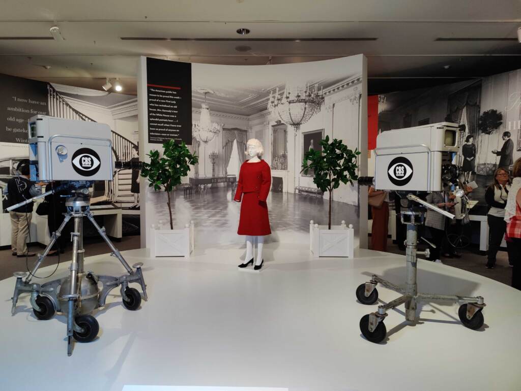 A mock-up of the CBS TV production inside the White House A mock-up of the CBS TV production inside the White House. The Jackie Kennedy mannequin is dressed in a re-creation of the red suit she wore for the TV house tour