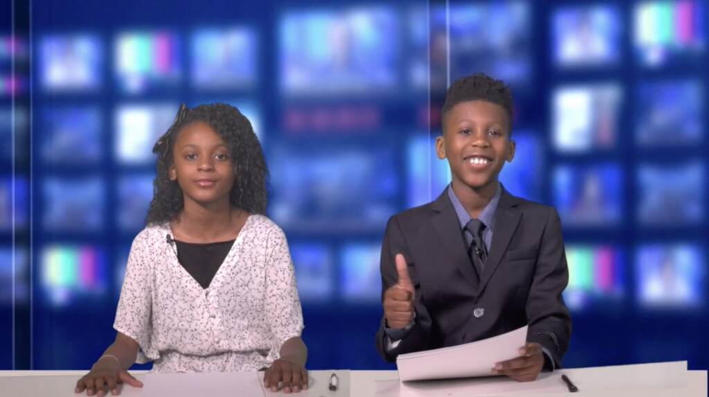 Katelynn Gibbs (L) and Jaxson Pointer (R) close out the film by thanking the audience for watching. Two children behind a news desk thank the audience for watching the film.
