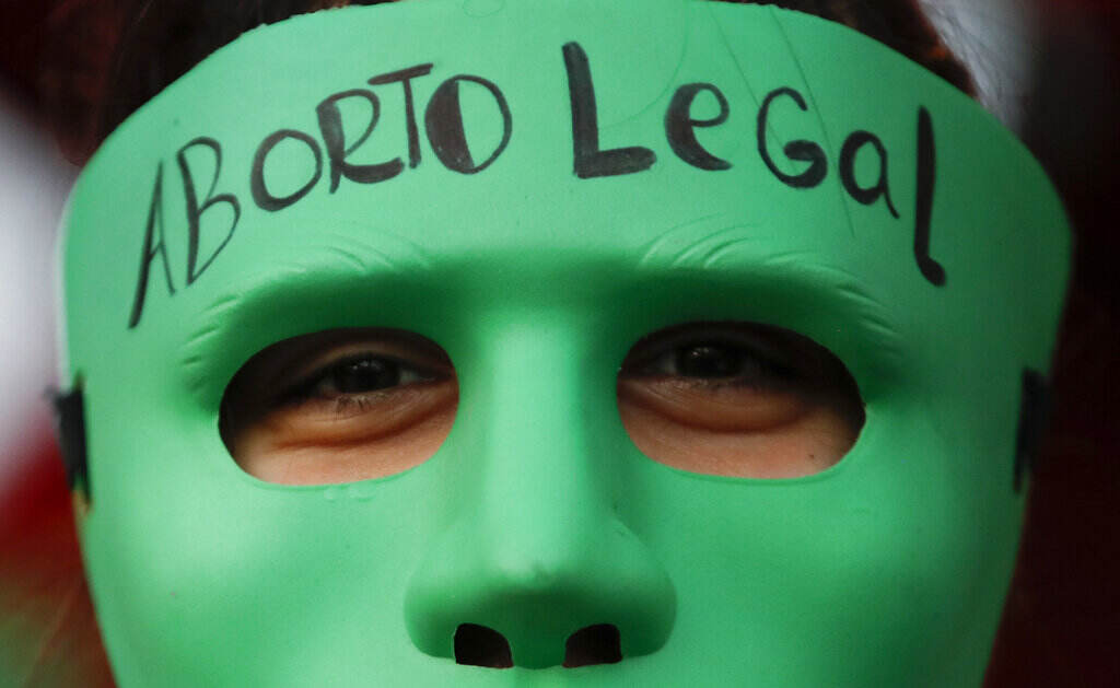 Supreme Court Abortion Global An abortion-rights activist wears a mask with text that reads in Spanish