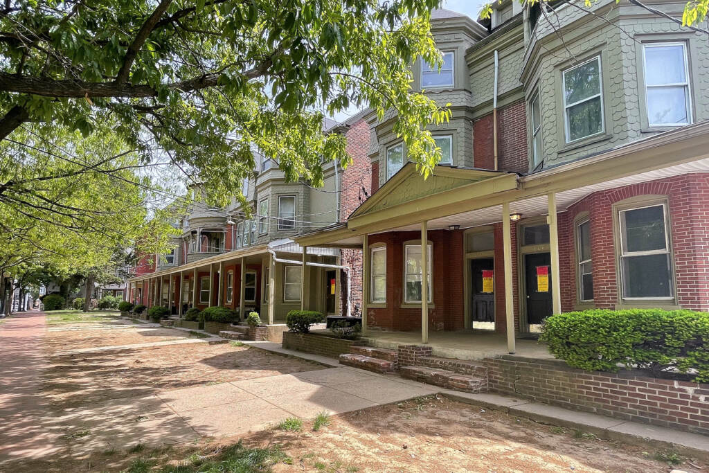 all-in-a-row-c-barrish-2022-05-18 The condemned apartment buildings are on the 800 block of Adams Street, one block off I-95. (Cris Barrish/WHYY)