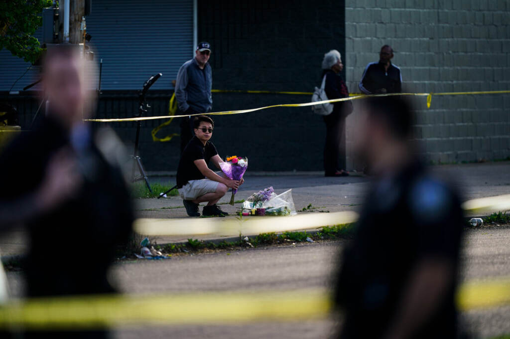 Buffalo Supermarket Shooting A person places flowers outside the scene of a shooting at a supermarket in Buffalo, N.Y., Sunday, May 15, 2022.