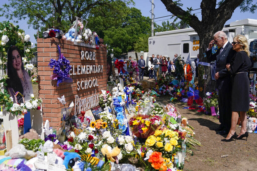 President Joe Biden and First Lady Jill Biden stand in front of a memorial to the victims of the mass shooting in Uvalde, Texas.