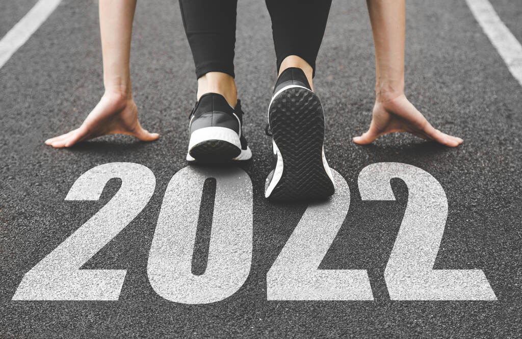 Close-up Of Female Feet In Sneakers At The Start. Beginning And close-up of feet in sneakers at the start of the new year 2022
