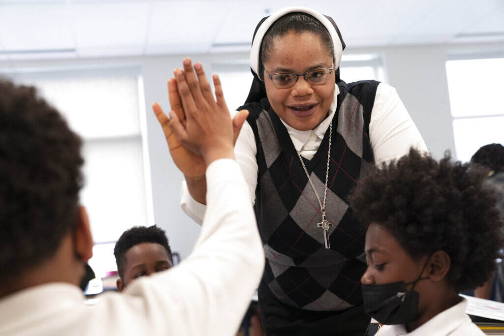 Delphine Okoro ister Delphine Okoro, a nun with the Oblate Sisters of Providence, high fives a student as she teaches a fifth grade class at Mother Mary Lange Catholic School in Baltimore, Md., Wednesday, April 27, 2022.