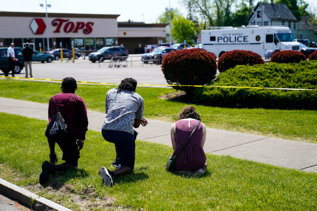 Buffalo Supermarket Shooting Targeted Violence People pray outside the scene of a mass shooting at a supermarket