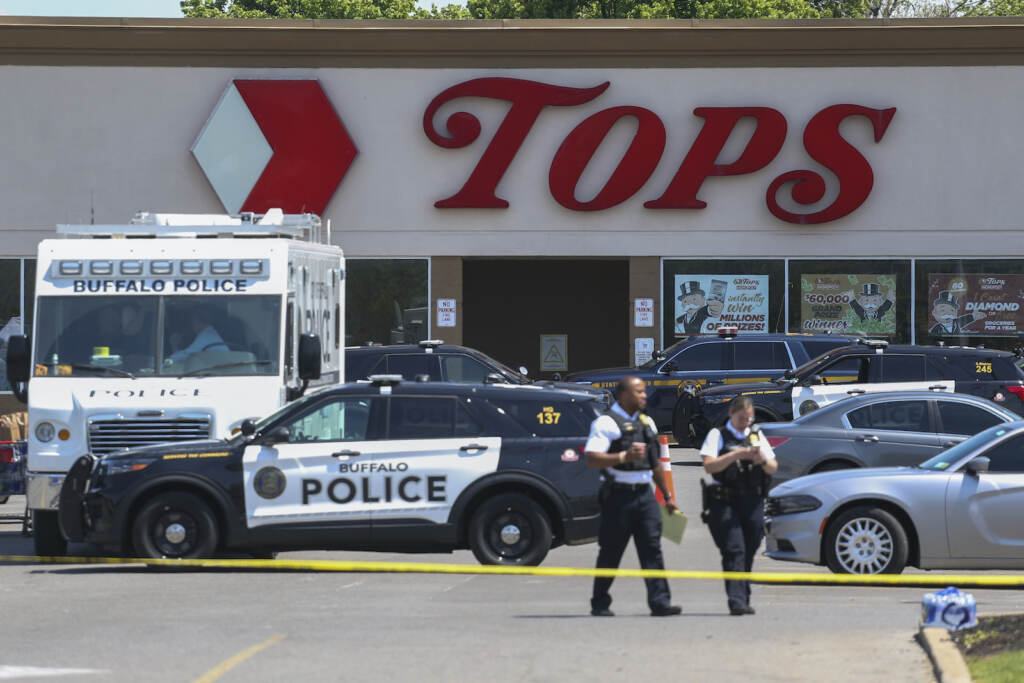 Buffalo Supermarket Shooting Police walk outside the Tops grocery store following a mass shooting
