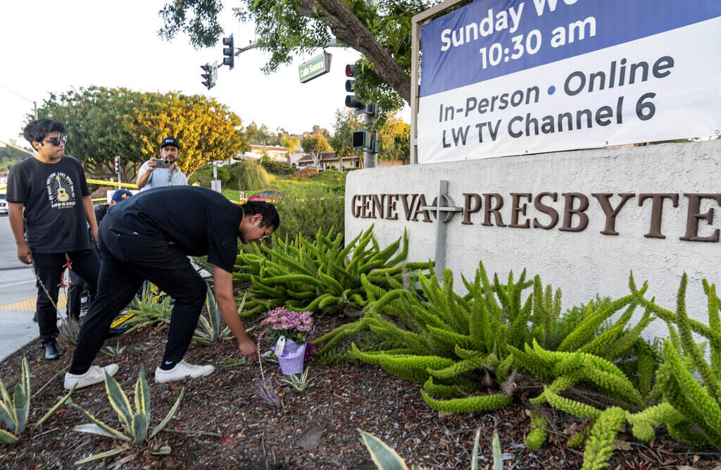 California Church Shooting Hector Gomez, left, and Jordi Poblete, worship leaders at the Mariners Church Irvine, leave flowers outside the Geneva Presbyterian Church in Laguna Woods, Calif., Sunday, May 15, 2022, after a fatal shooting.