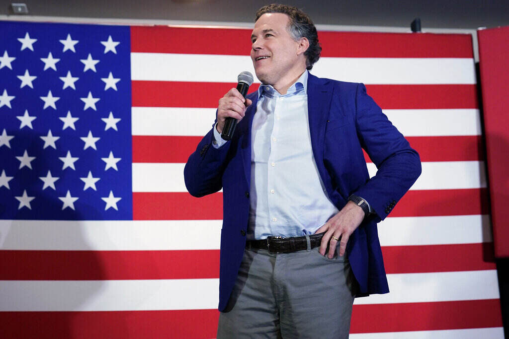 Election 2022 Pennsylvania Senate Dave McCormick stands in front of a U.S. flag, with his hand on his hip.