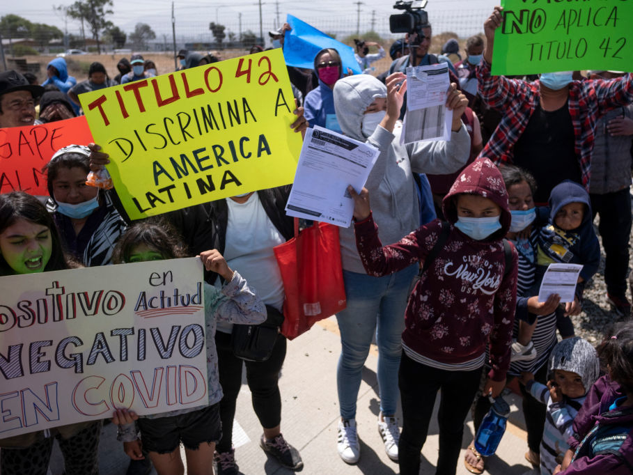 Migrants and asylum seekers protest outside the United States Consulate against the public health order known as Title 42, in Tijuana, Mexico, on May 19, 2022. Migrants and asylum seekers protest outside the United States Consulate against the public health order known as Title 42, in Tijuana, Mexico, on May 19, 2022. (Guillermo Arias/AFP via Getty Images)