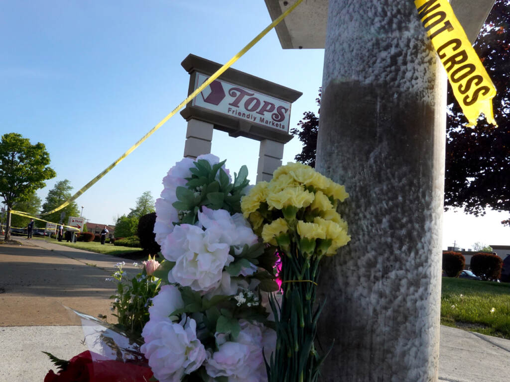Flowers are left at a makeshift memorial outside of the Tops market on May 15 in Buffalo, N.Y. Flowers are left at a makeshift memorial outside of the Tops market on May 15 in Buffalo, N.Y. (Scott Olson/Getty Images)