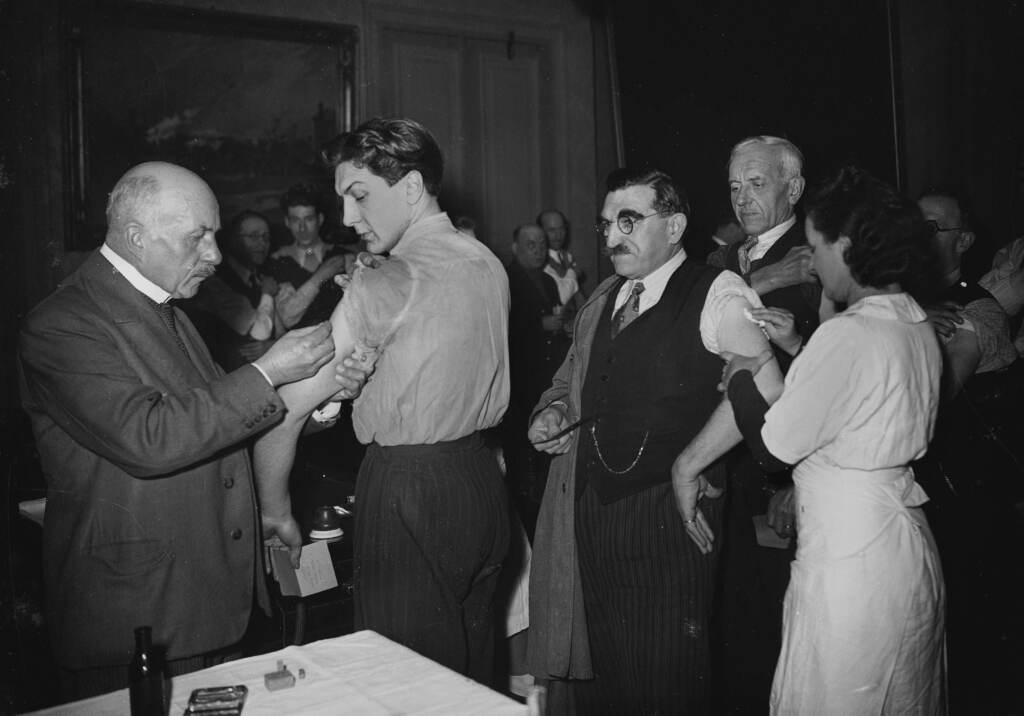 Smallpox vaccines being administered in Paris in 1941. When the disease was eradicated and vaccination came to a stop, that created an opening for its virus relative monkeypox. (Roger Viollet via Getty Images)