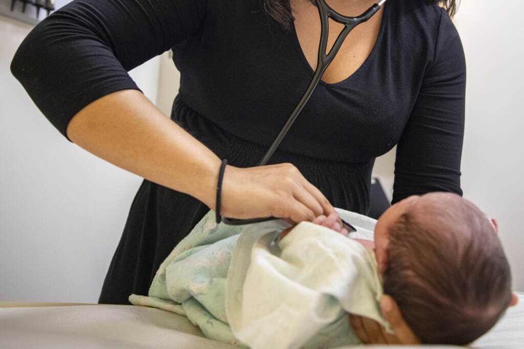 Pediatricians Race A pediatrician examines a newborn baby