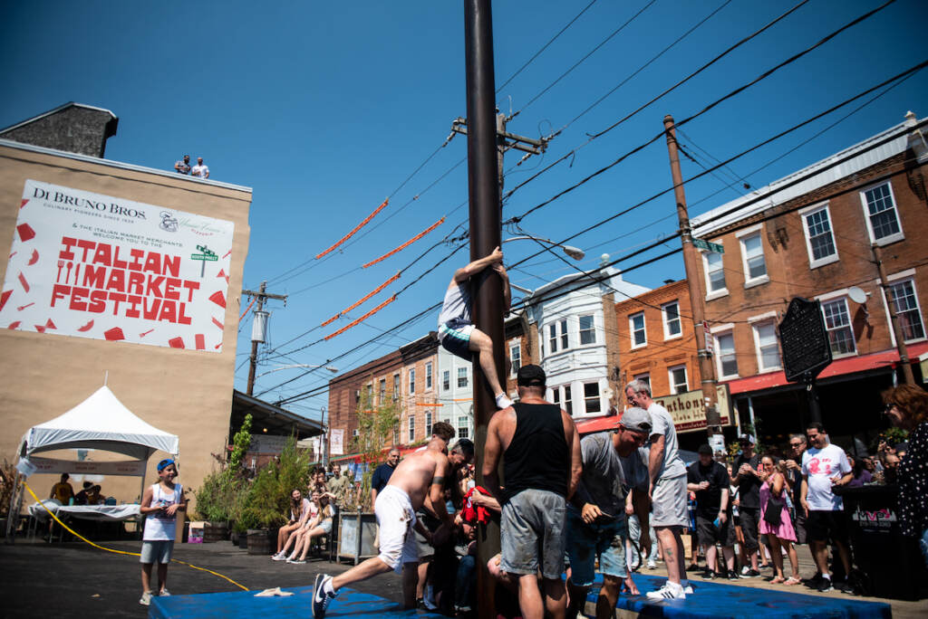 italianmarketfestival-greasepole07 Climbers struggle as their teammates climb on their shoulders during the greased pole competition in Montrose Piazza on Sunday, May 22, 2022.