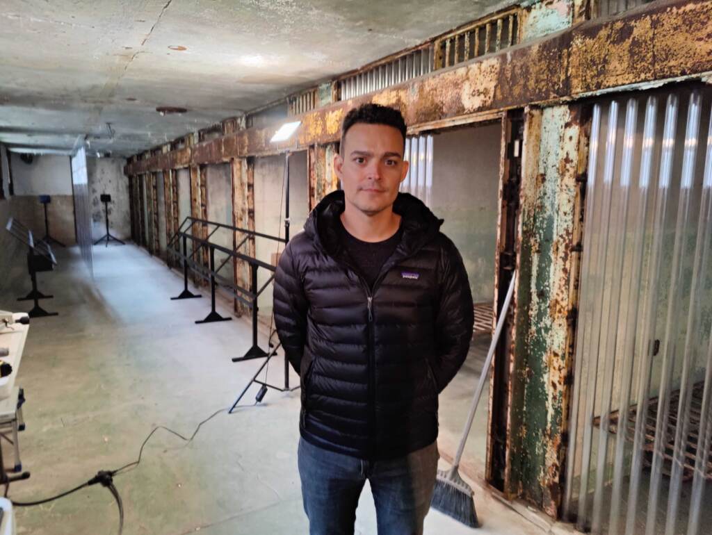 mark-menjivar-esp-exhibition Mark Menjivar stands in the exhibition space at the Eastern State Penitentiary.