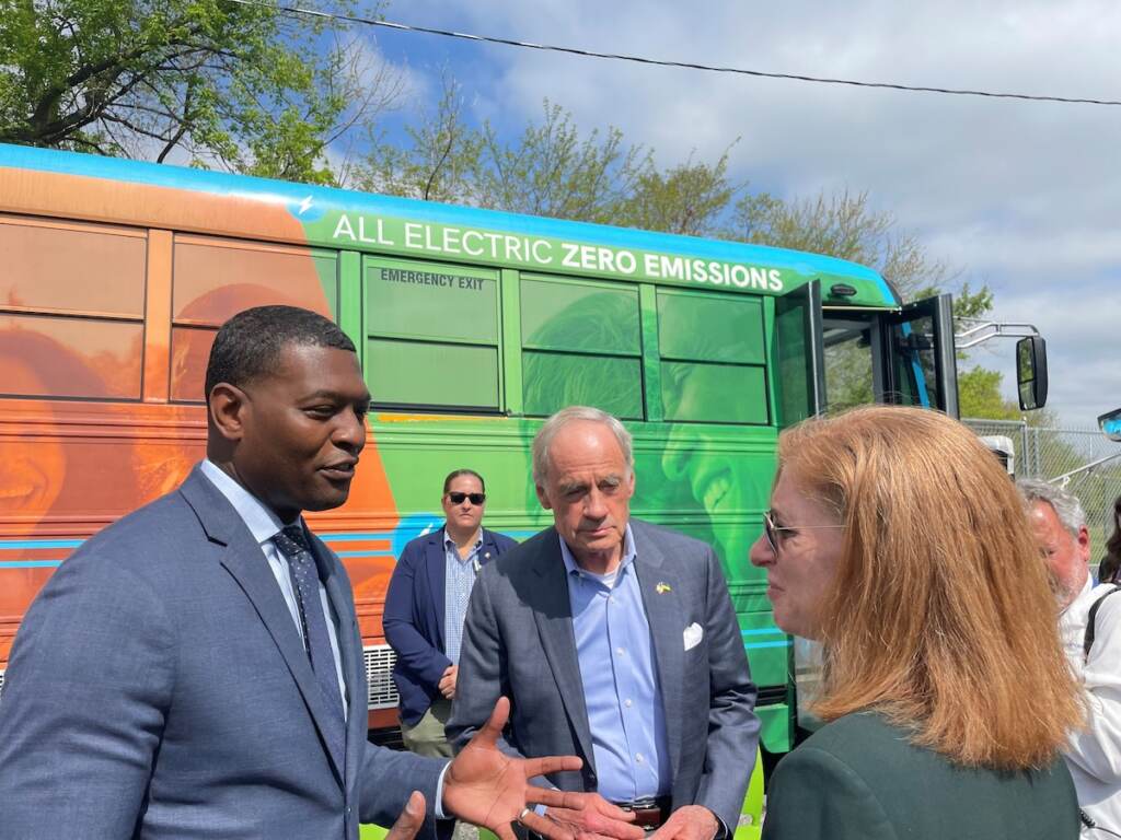 regan carper EPA chief Michael Regan (left) talks with U.S. Sen. Tom Carper and an unidentified woman at The Warehouse for teens in Wilmington. Behind them is the center's electric bus.