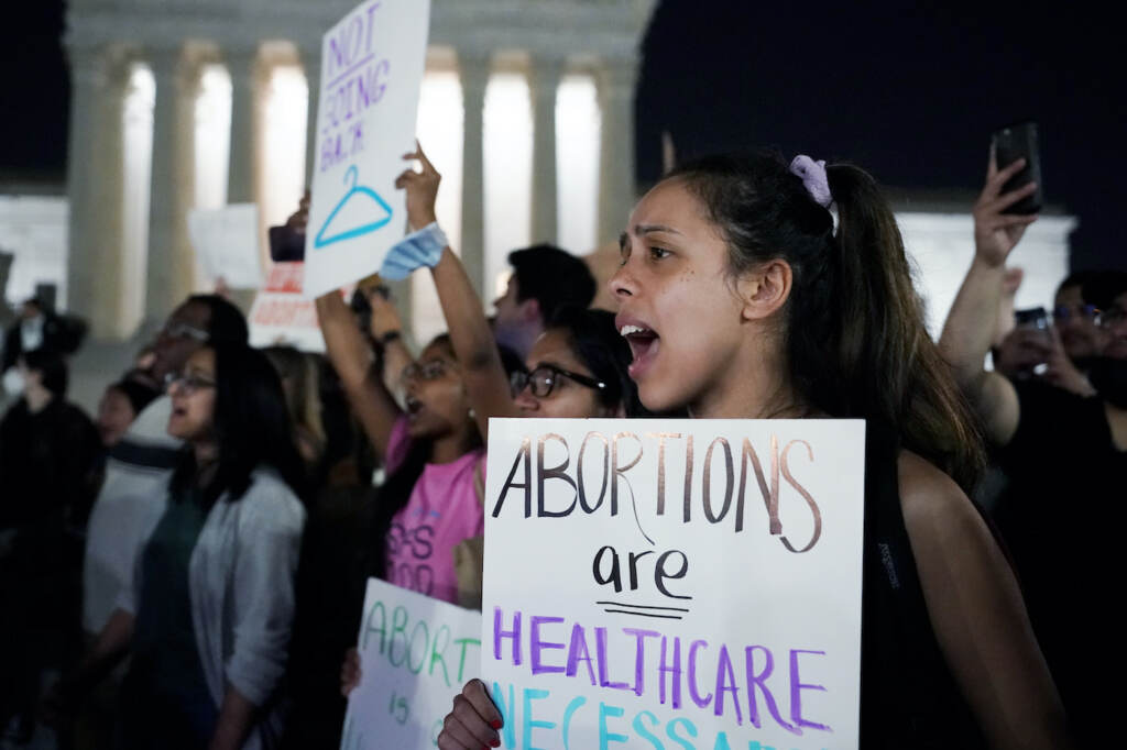 A crowd of people gather outside the Supreme Court protesting a draft opinion regarding Roe v. Wade