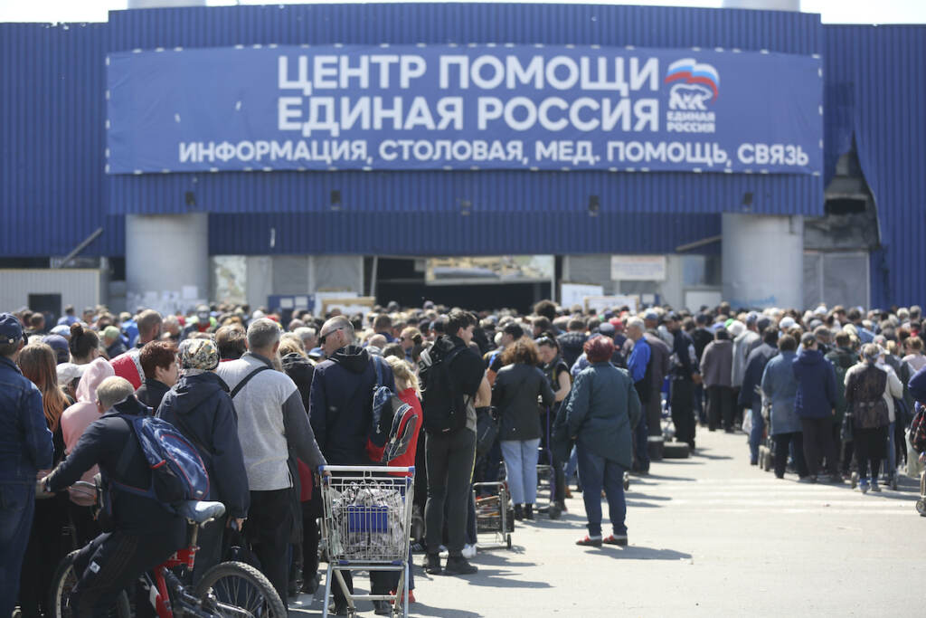 Ukraine Russia Local civilians line up to get humanitarian aid distributed in the United Humanitarian Center in Mariupol