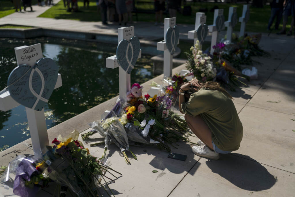 Texas School Shooting Elena Mendoza grieves in front of a cross honoring her cousin, Amerie Jo Garza