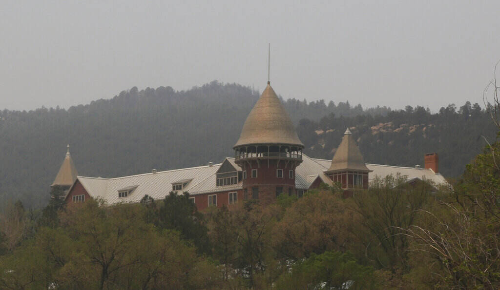 Spring Wildfires The United World College of the American West sits empty of students but unharmed, while trees can be seen behind it scorched from Las Vegas, N.M., on Saturday, May 7, 2022. School officials were able to visit the grounds earlier this week after winds and fires waned. Students at the boarding school most of whom are from overseas, have been moved to a summer camp outside Santa Fe, N.M.
