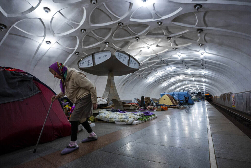APTOPIX Russia Ukraine War An elderly woman walks inside a metro station being used as a bomb shelter in Kharkiv, Ukraine, Thursday, May 12, 2022.