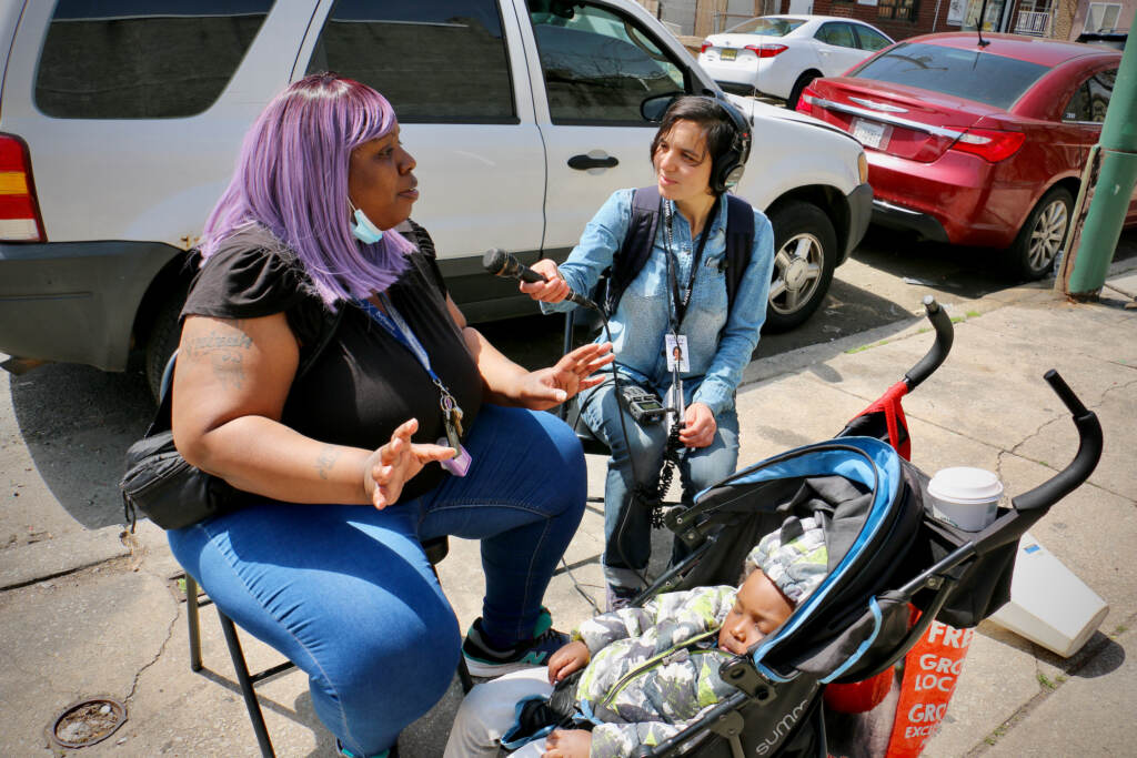 2022 04 16-e lee-tamika borum sammy caiola-philadelphia grays ferry-tynirah’s garden interview WHYY's Sammy Caiola talks with Tamika Borum at Tynirah's Community Welcome Garden in Gray's Ferry. The garden was named in honor of Borum's daughter, who was shot to death in 2014 at the age of 3 outside her home. (Emma Lee/WHYY)