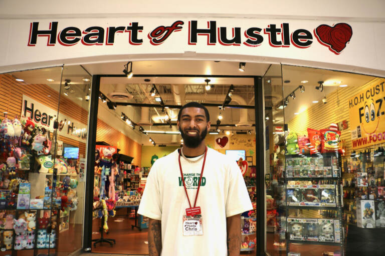 Chris Newsome stands in front of Heart of Hustle at the Cumberland Mall