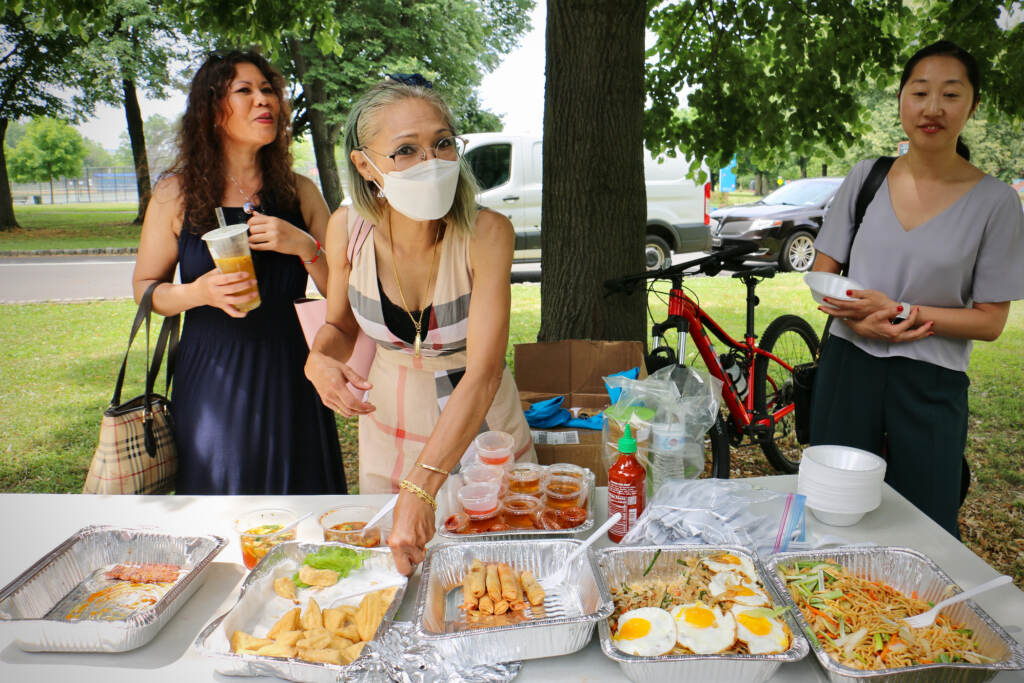 2022 06 08-e lee-saijai sabayjit-philadelphia FDR park-southeast asian market Saijai Sabayjit (center) of Saijai Thai sets out samples of her fried tofu. She is one of three vendors from the Southeast Asian Market at FDR Park chosen to serve food at the Philadelphia Flower Show. (Emma Lee/WHYY)