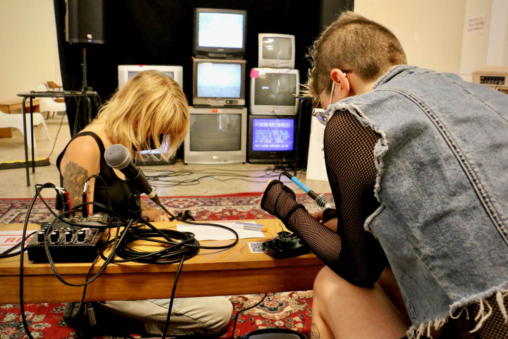 2022 06 23-e lee-elissa anderson jackie milestone-philadelphia asian arts initiative-body conduit electromagnetic exhibit Elissa Anderson (left) and Jackie Milestone of the Sound Museum Collective work on the broadcast lounge that is part of thier exhibit at the Asian Arts Initiative. (Emma Lee/WHYY)