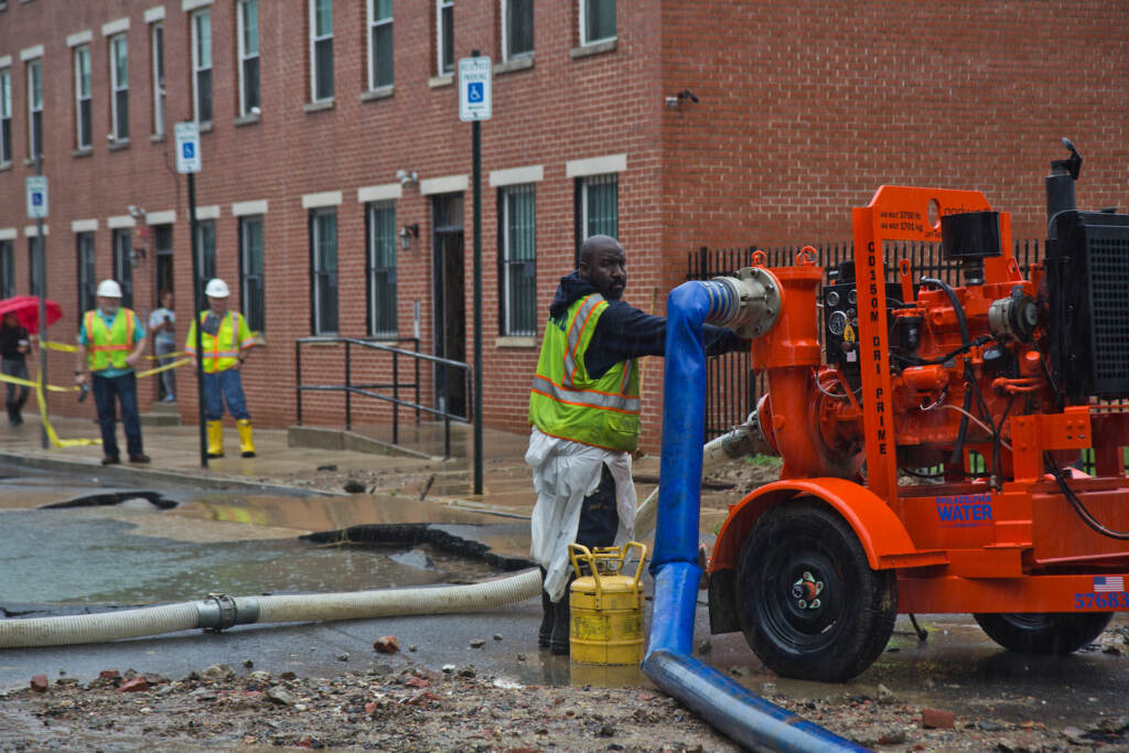 Crews are pictured at the scene of a water main break near Fourth and Hewson streets