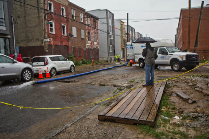 Crews are pictured at the scene of a water main break near Fourth and Hewson streets
