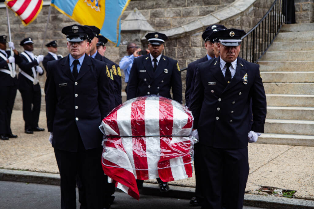 2022 06 27 kpaynter Lt. Sean Williamson funeral service-4 Officers carry a casket draped with the American flag.