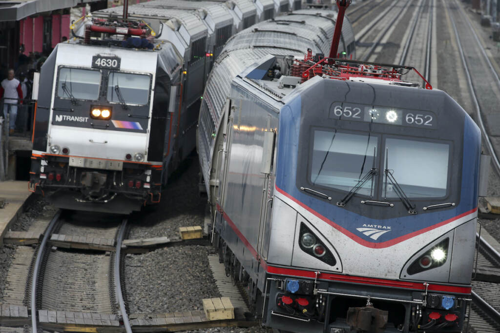New Jersey Transit, transportation, commuter rail, Amtrak, Northeast Corridor In this March 12, 2016, file photo, an Amtrak train passes a New Jersey Transit train stopped to discharge and board passengers at Elizabeth train station in Elizabeth, N.J., along Amtrak's Northeast Corridor. (AP Photo/Mel Evans, File)