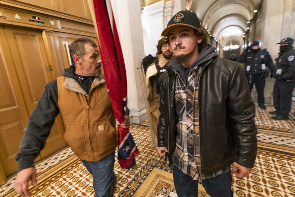 Capitol Riot Bench Trial Kevin Seefried (left) and his son Hunter march through the U.S. Capitol during the Jan. 6, 2021 insurrection.