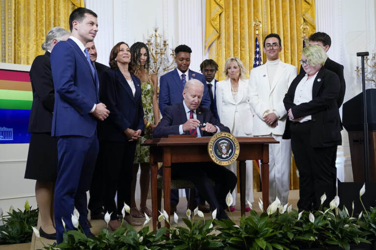 President Joe Biden signs an executive order at an event to celebrate Pride Month in the East Room of the White House, Wednesday, June 15, 2022, in Washington. (AP Photo/Patrick Semansky)