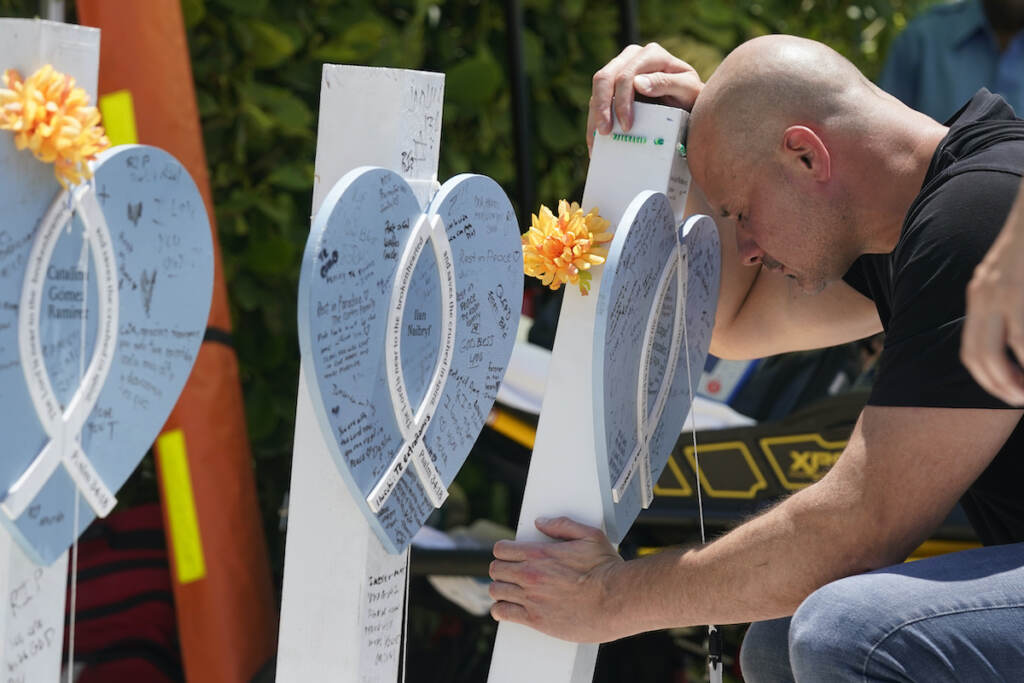 Lazaro Carnero Lazaro Carnero mourns for his best friend Edgar Gonzalez, during a remembrance event at the site of the Champlain Towers South building collapse, Friday, June 24, 2022, in Surfside, Fla. (AP Photo/Wilfredo Lee)