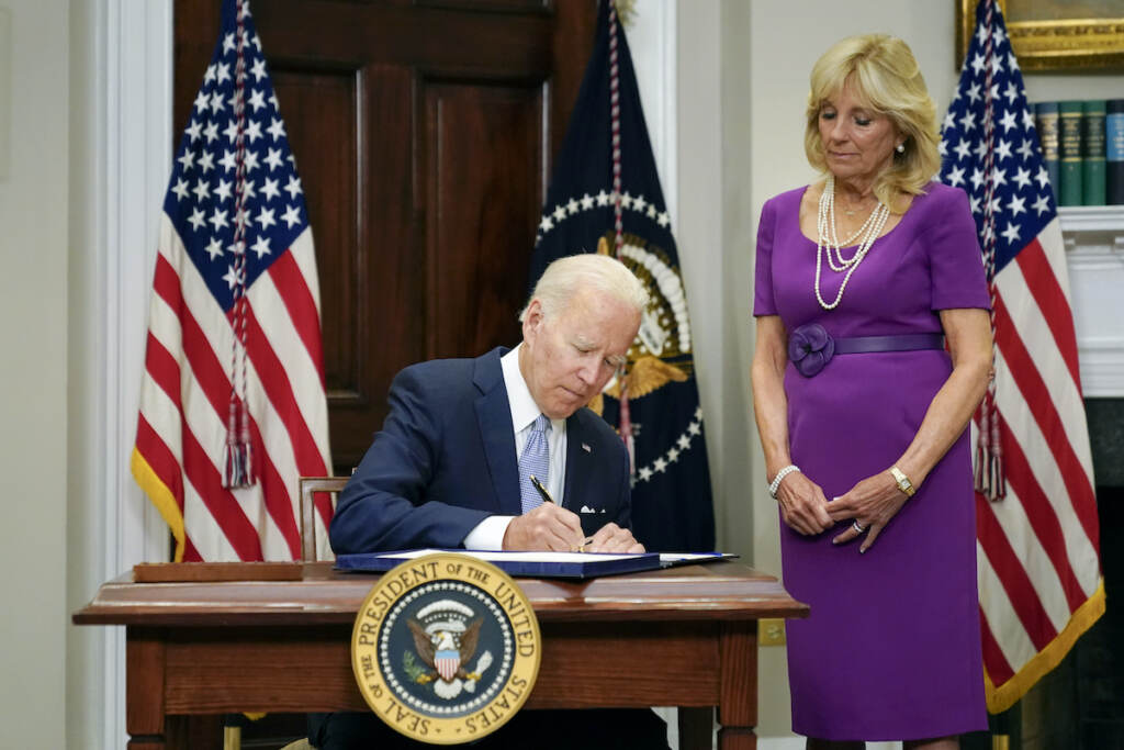 Biden Guns President Joe Biden signs into law S. 2938, the Bipartisan Safer Communities Act gun safety bill, in the Roosevelt Room of the White House in Washington, Saturday, June 25, 2022. First lady Jill Biden looks on at right. (AP Photo/Pablo Martinez Monsivais)