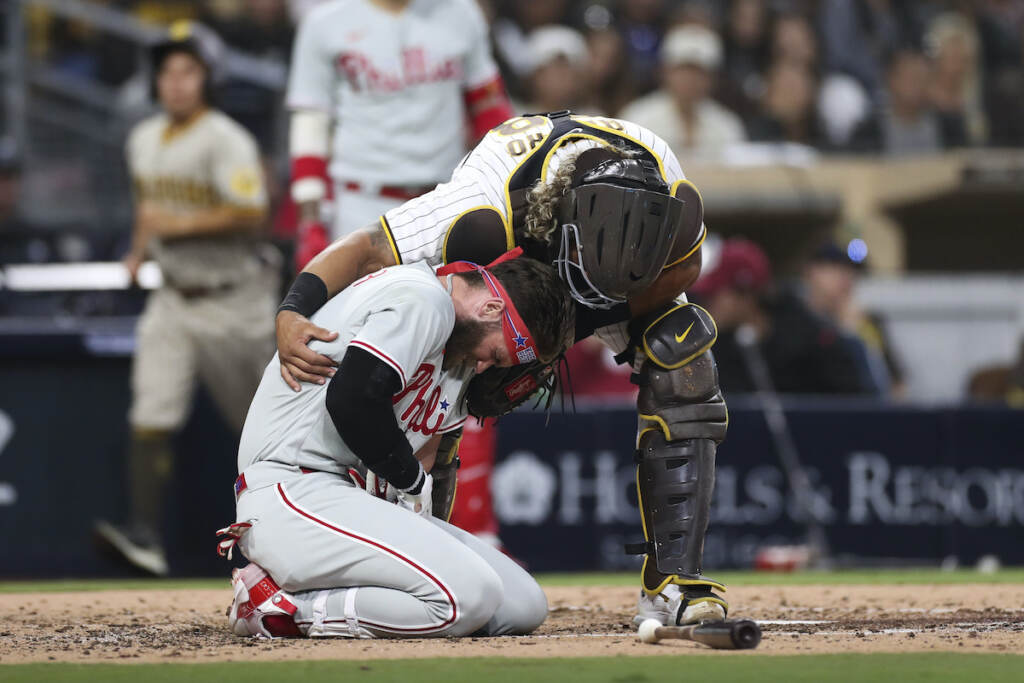 Phillies Padres Baseball Philadelphia Phillies' Bryce Harper, bottom, reacts after being hit by a pitch from San Diego Padres' Blake Snell as Padres catcher Jorge Alfaro checks on him duirng the fourth inning of a baseball game Saturday, June 25, 2022, in San Diego. (AP Photo/Derrick Tuskan)