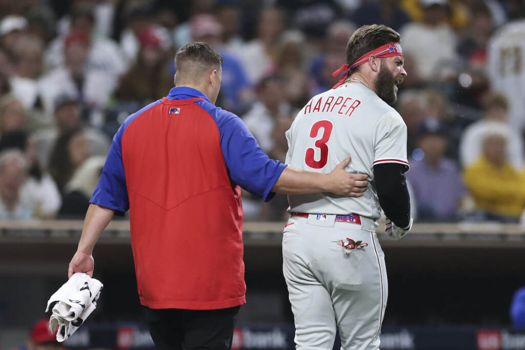 APTOPIX Phillies Padres Baseball Philadelphia Phillies' Bryce Harper, right, reacts towards San Diego Padres' Blake Snell after being hit by a pitch from Snell, as he walks off the field with a trainer during the fourth inning of a baseball game Saturday, June 25, 2022, in San Diego. (AP Photo/Derrick Tuskan)