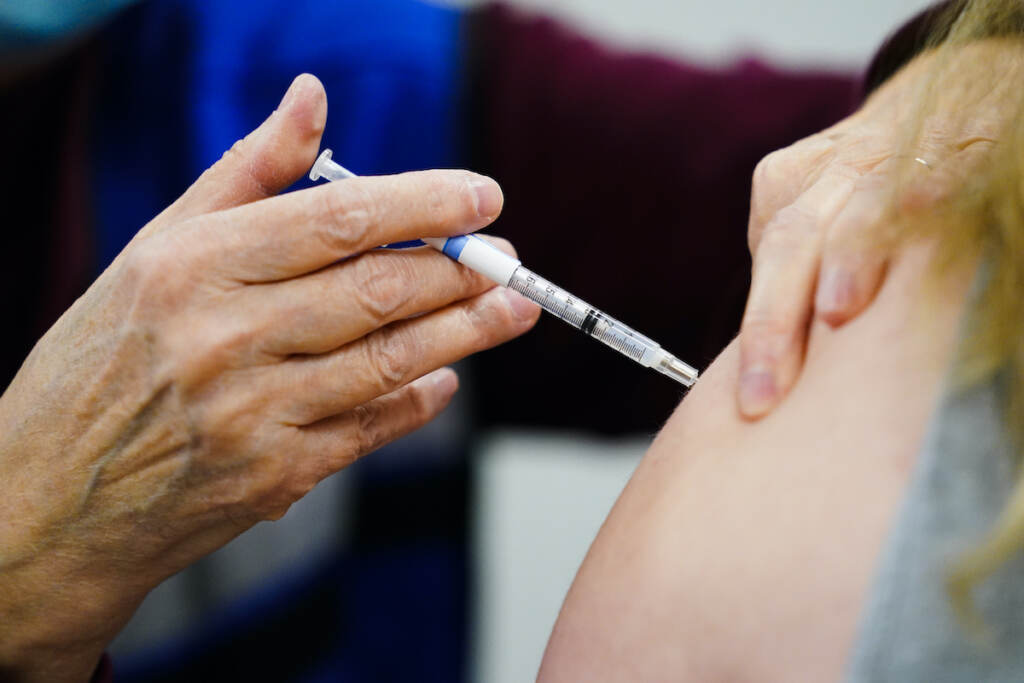 Virus Outbreak Updating Vaccines A health worker administers a dose of a COVID-19 vaccine during a vaccination clini