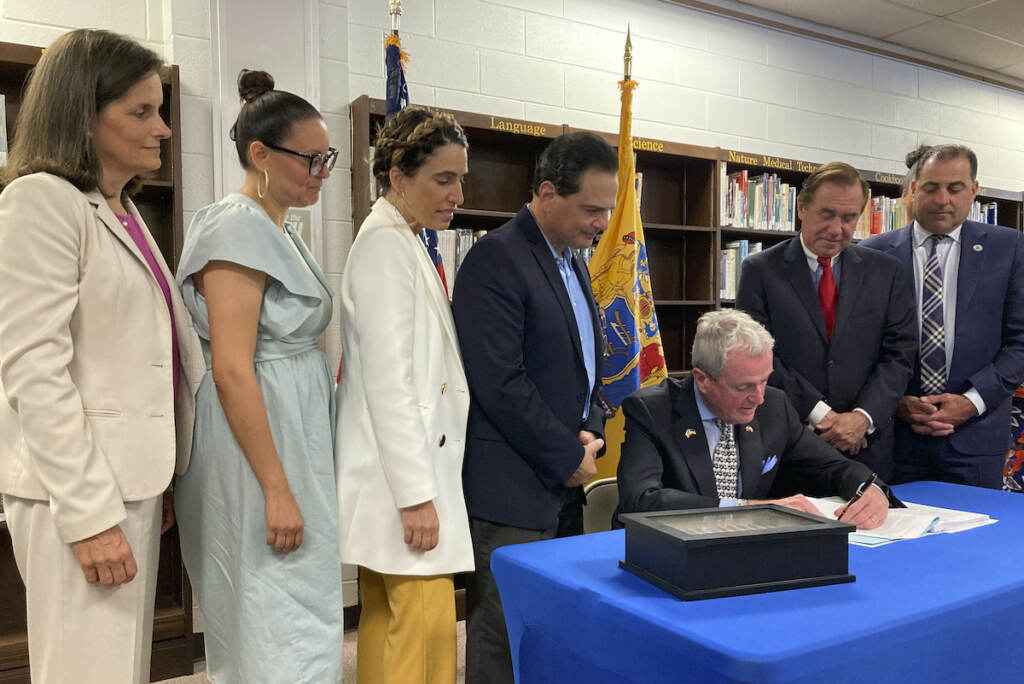 New Jersey Budget New Jersey Democratic Gov. Phil Murphy (seated) signs the $50.6 billion fiscal year 2023 budget, Thursday, June 30, 2022, in Cranford, N.J. The bill sets aside $2 billion for property tax relief and carries a nearly $7 billion surplus into the new year. Flanking the governor from left to right are state Treasurer Elizabeth Muoio, Assembly member Eliana Pintor Marin, state Senate Majority Leader Teresa Ruiz, Senate President Nicholas Scutari, Assembly Speaker Craig Coughlin and state Sen. Paul Sarlo. (AP photo/Mike Catalini), (