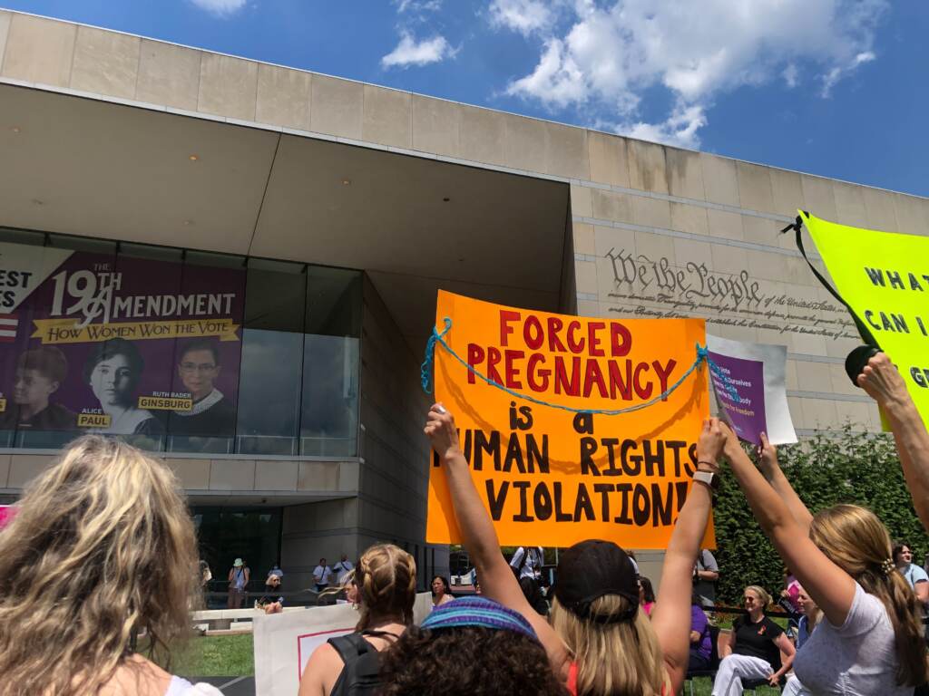 Image from iOS (70) Rally-goers hold up signs at the rally in defense of abortion rights at Philadelphia’s National Constitution Center on June 25, 2022. (Emily Rizzo/WHYY)
