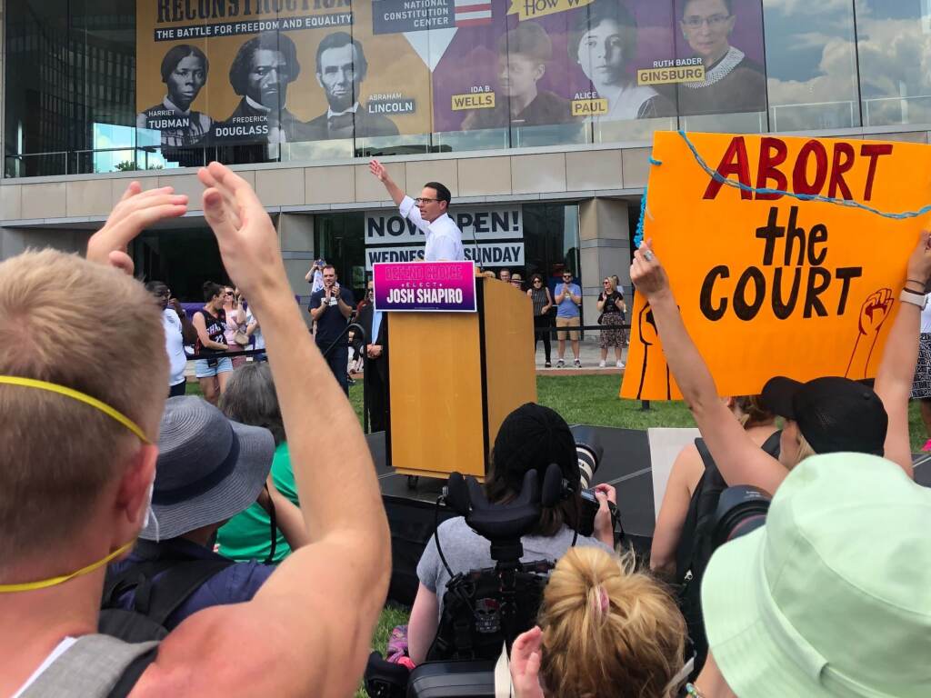 Image from iOS (73) (2) Josh Shapiro addresses a crowd of hundreds of people, rallying in defense of abortion rights at Philadelphia’s National Constitution Center on June 25, 2022. (Emily Rizzo/WHYY)