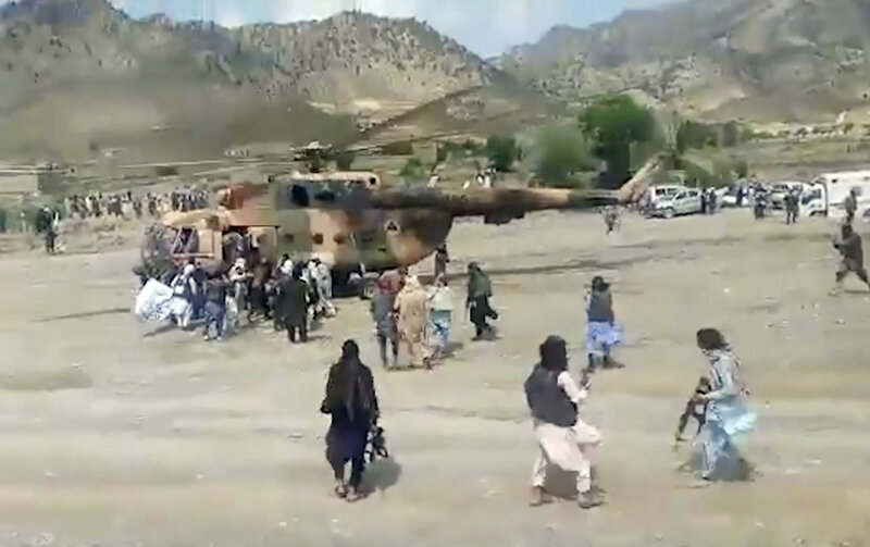 Afghanistan Earthquake Taliban fighters secure a government helicopter to evacuate injured people in Gayan district