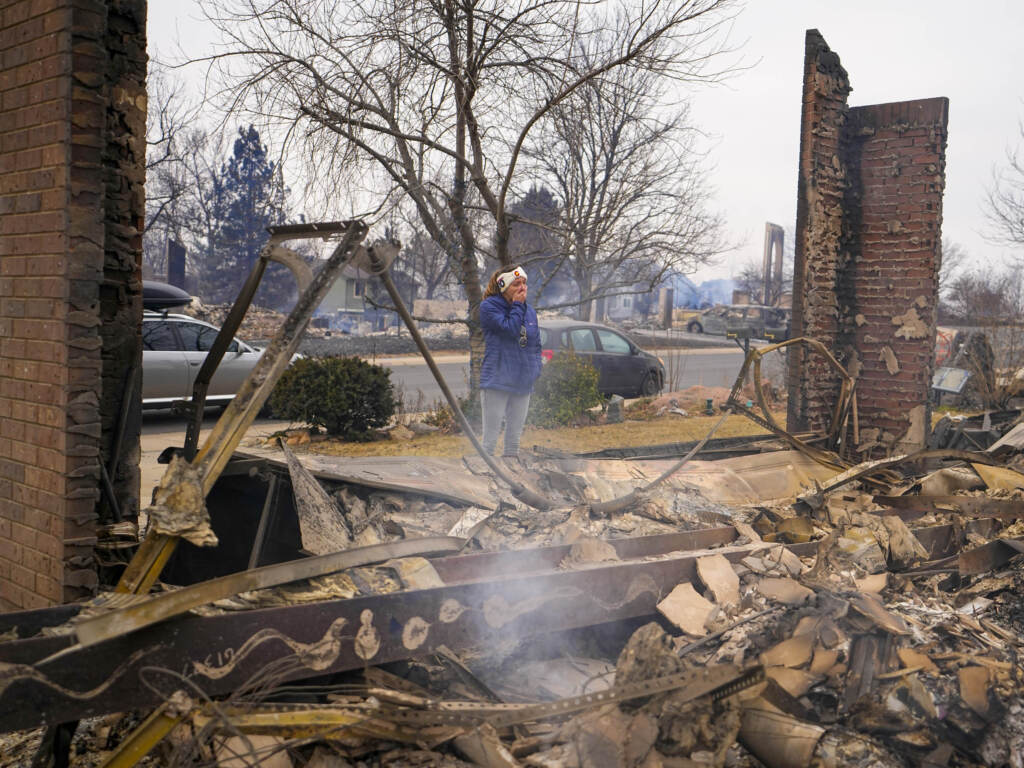 A woman reacts to seeing the remains of her mother’s home destroyed by the Marshall Wildfire in Louisville, Colo., in 2021. A new survey finds that most Americans say they have experienced extreme weather in the last five years. A woman reacts to seeing the remains of her mother's home destroyed by the Marshall Wildfire in Louisville