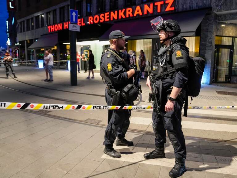 Police stand guard outside a bar in central Oslo, early Saturday. Norwegian police say two people have been killed and several injured in a mass shooting. (Javad Parsa/AP)