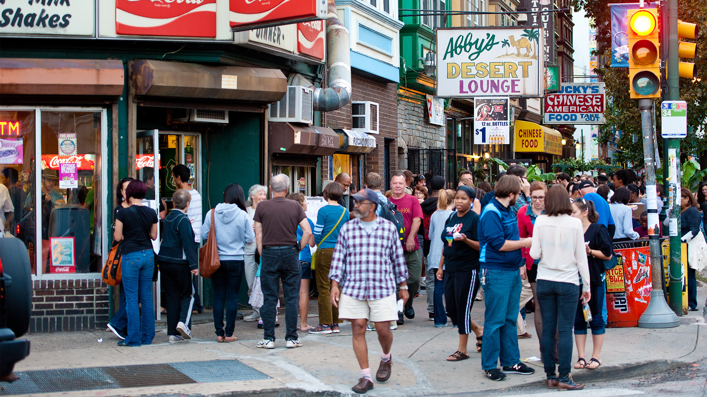 People are seen on Baltimore Avenue during the Dollar Stroll