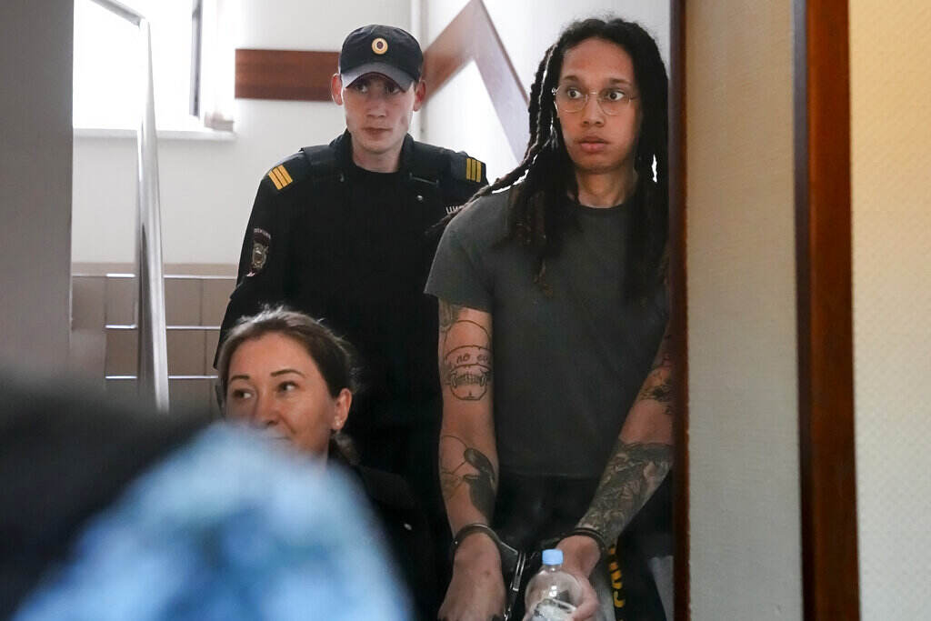 Brittany Griner looks surprised as she led into a courtroom in handcuffs.