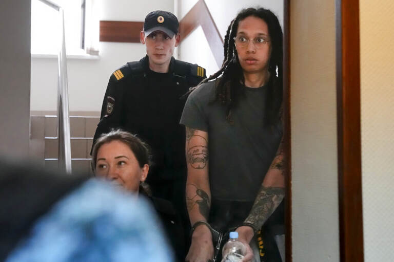 Brittany Griner looks surprised as she led into a courtroom in handcuffs.